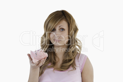 Blond-haired woman sad with her broken piggybank