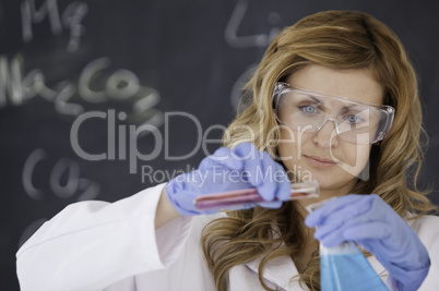 Young female scientist carrying out an experiment