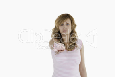 Attractive blond-haired woman showing her broken piggybank