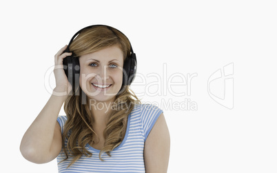 Isolated blond-haired woman listening to music