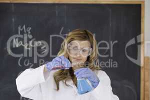 Young blond-haired woman carrying out an experiment