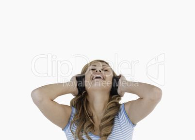 Attractive blond-haired woman happy while listening to music