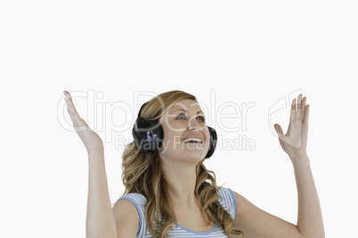 Cute blond-haired woman enjoying while listening to music