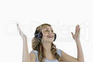 Cute blond-haired woman enjoying while listening to music