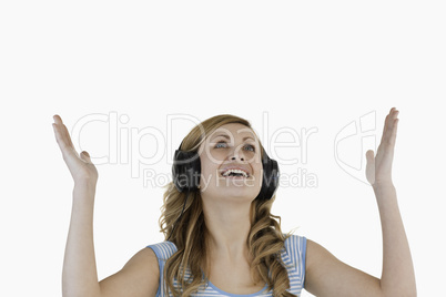 Isolated blond-haired woman happy while listening to music