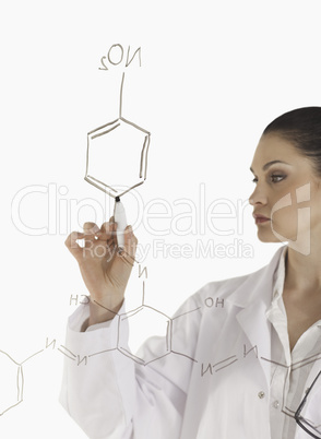 Isolated scientist writing a formula on a white board