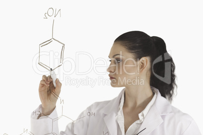 Isolated woman writing a formula on a white board