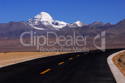 Landscape of snow-capped mountains and a road
