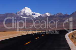 Landscape of snow-capped mountains and a road