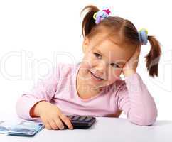 Little girl with few paper euro banknotes