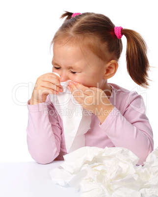 Little girl blows her nose