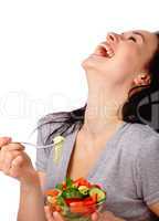 Young attractive woman eats vegetable salad