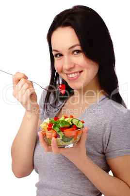 Young attractive woman eats vegetable salad