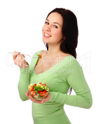 Young attractive woman eats vegetable salad