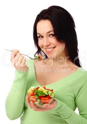 Young attractive woman eats vegetable salad