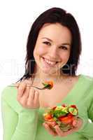 Young attractive woman eats vegetable salad