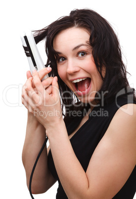 Woman is screaming while using hair straightener