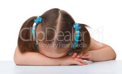 Little girl is sleeping at table