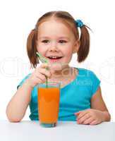 Happy little girl with orange juice