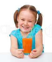 Happy little girl with orange juice