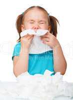 Little girl blows her nose