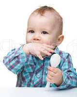 Cute little boy is biting his finger