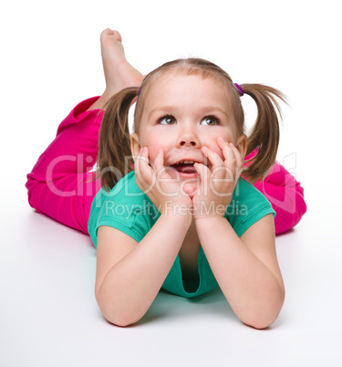 Portrait of a cute little girl laying on floor