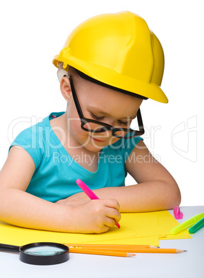 Cute little girl draw with marker wearing hard hat