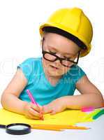 Cute little girl draw with marker wearing hard hat