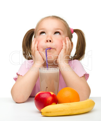 Little girl drinks fruit juice