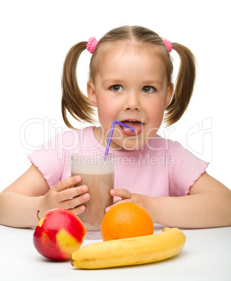 Little girl drinks fruit juice