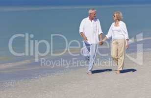 Happy Senior Couple Walking Holding Hands on Beach