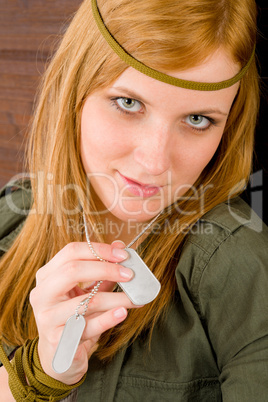 Hippie young woman in khaki outfit hold dog-tag