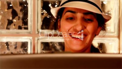 young woman on computer laughing