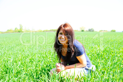 pretty woman sitting in the gras