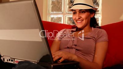 young woman on computer laughing 2