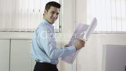 Architect with blueprints in office
