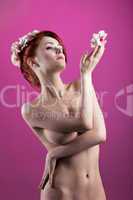 Beauty naked girl with flower and garland