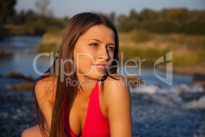 Young woman in red look at sunset