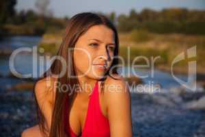 Young woman in red look at sunset