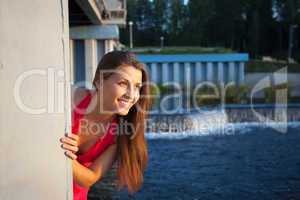 Young beauty woman in red smile and look at sunset