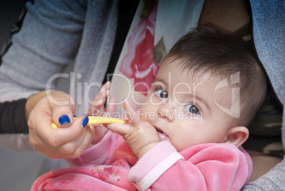 Baby Girl eating with her Mother