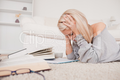 Attractive blond woman frustrated with her books
