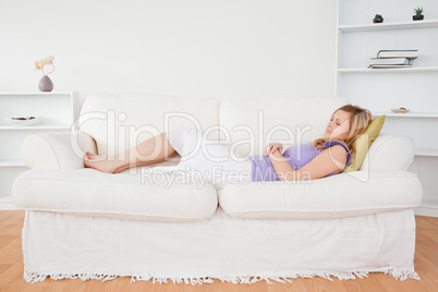 Beautiful woman taking a rest lying on a sofa