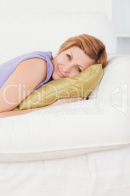 Portrait of a beautiful woman posing and smiling while lying on