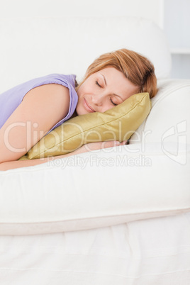 Portrait of an attractive woman taking a rest lying on a sofa
