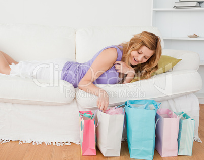 Attractive blond-haired woman lying on the couch