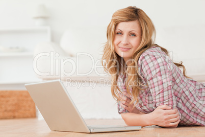 Attractive woman looking at the camera while chatting on her lap