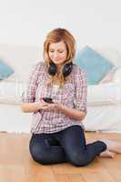 Blond-haired woman with headphones and mp3 player