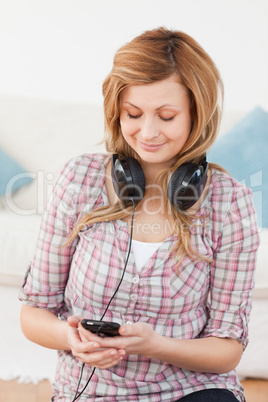 Blonde woman with headphones and mp3 player